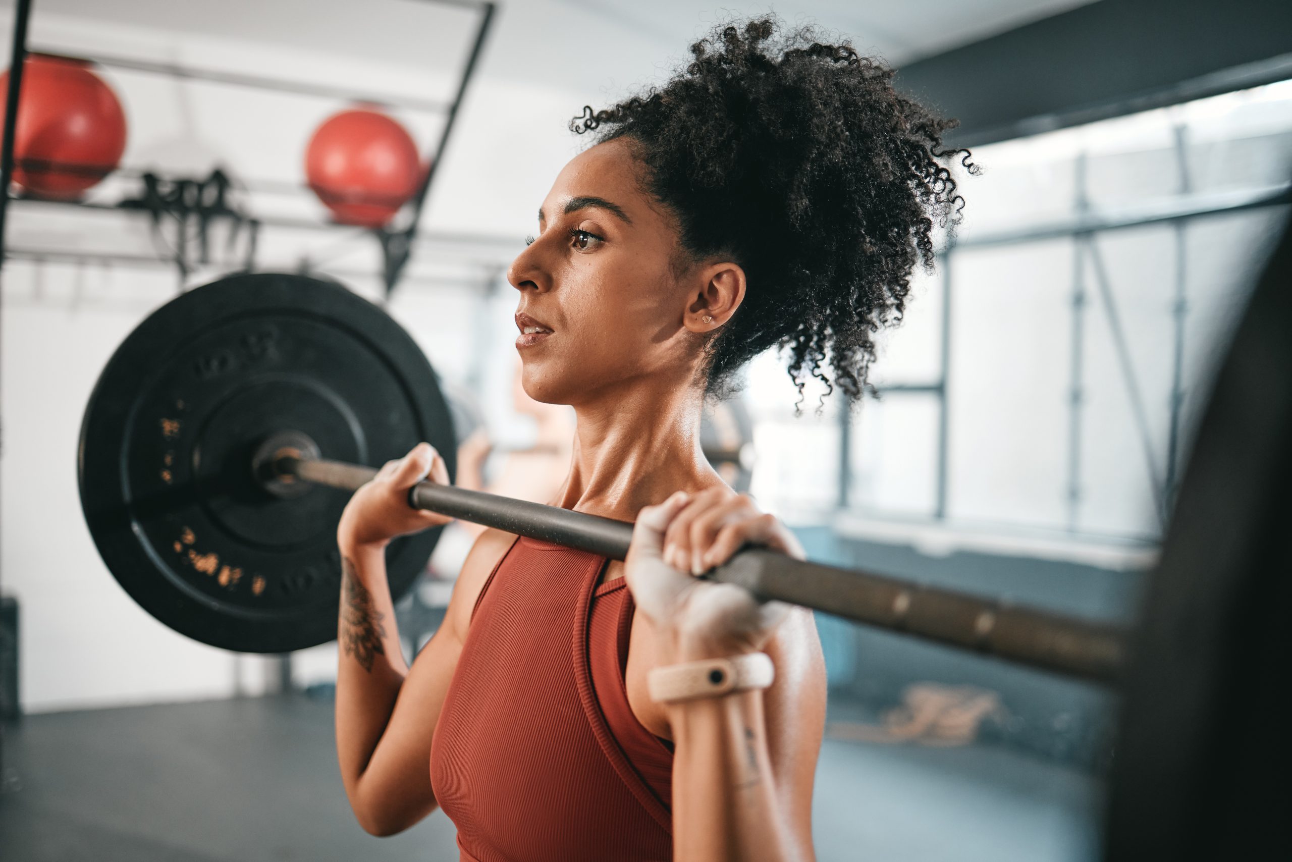 mid aged woman lifting weights in home gym