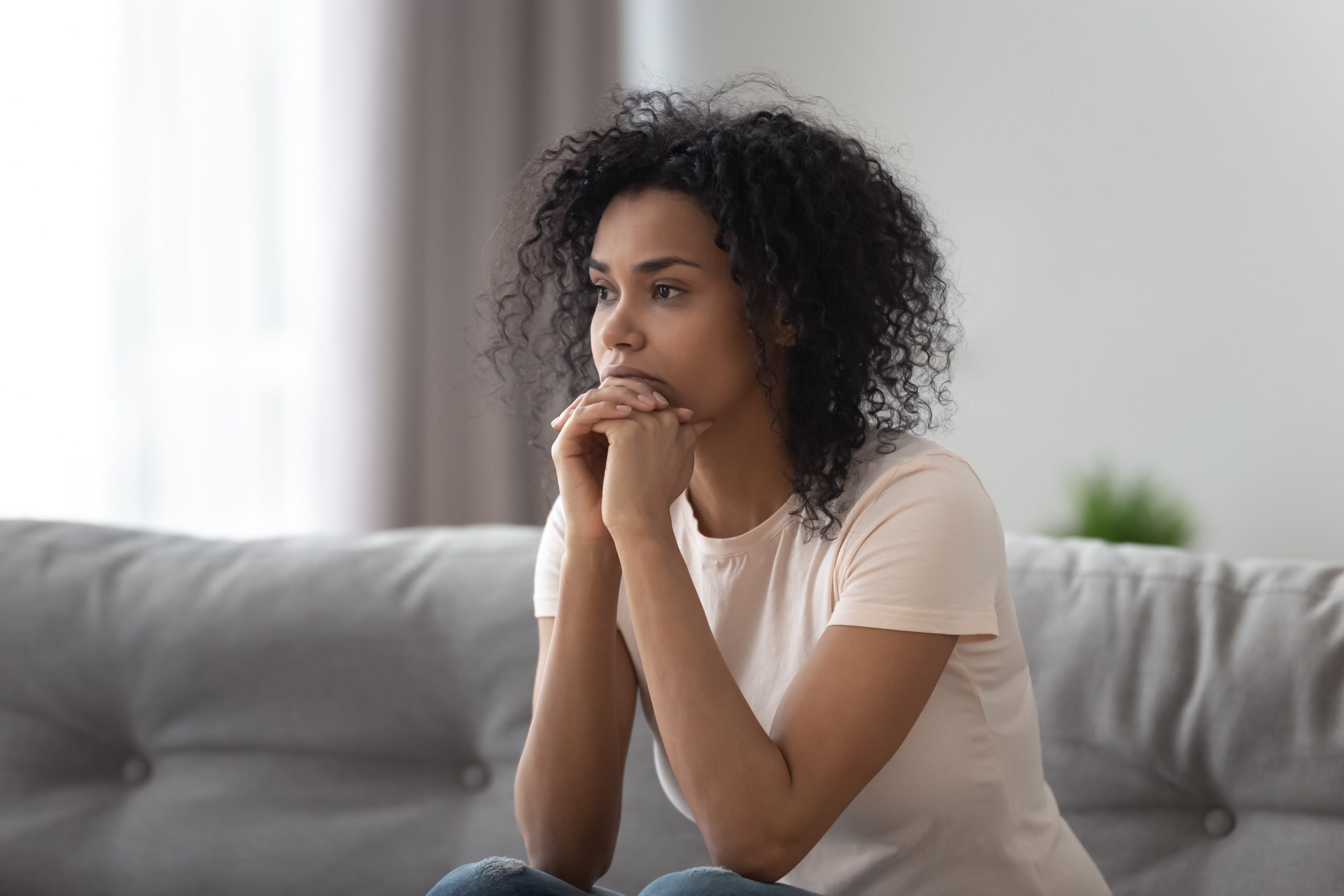Woman anxious at home alone.