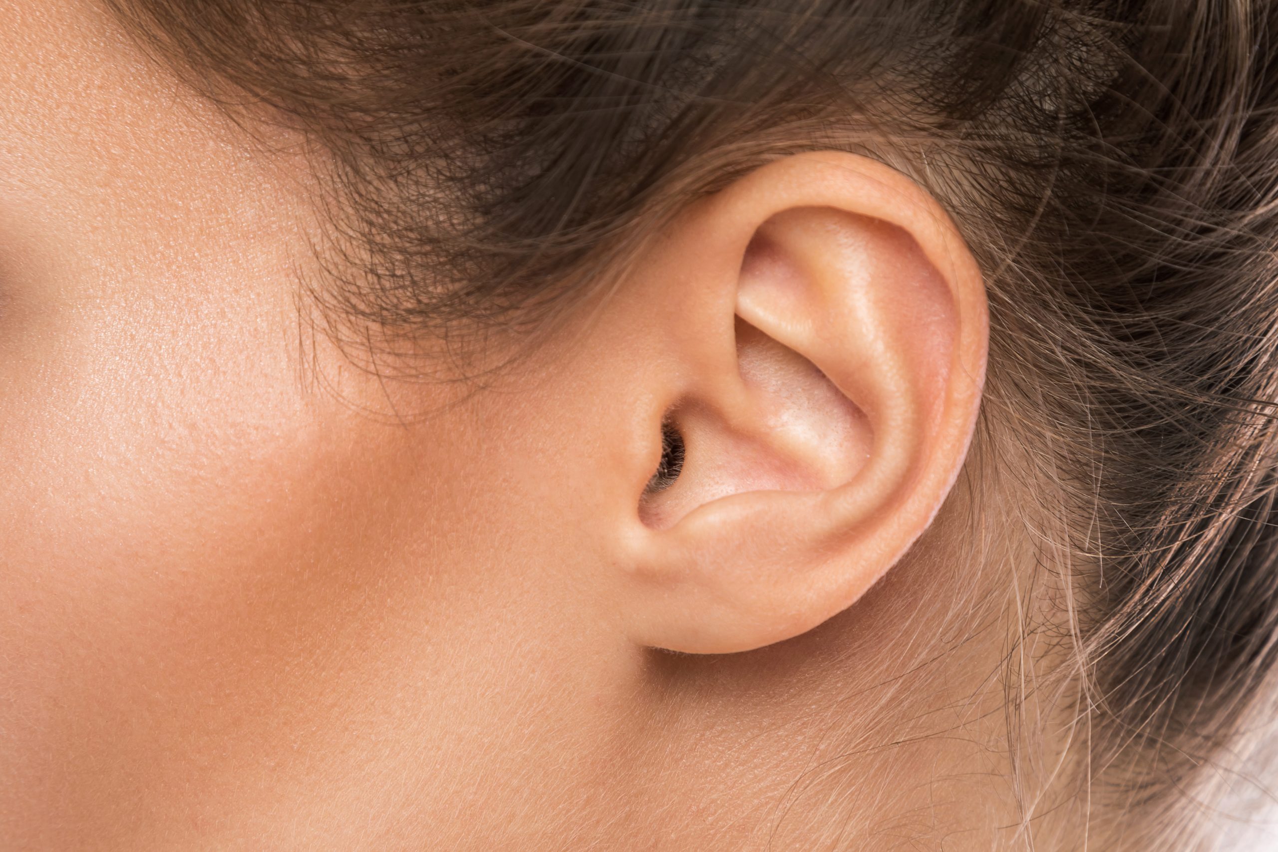 Close-up of a woman’s outer ear and ear canal.